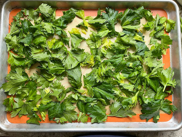 One layer of celery leaves in the pan