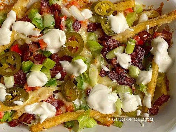dirty fries topped with peppers and sour cream