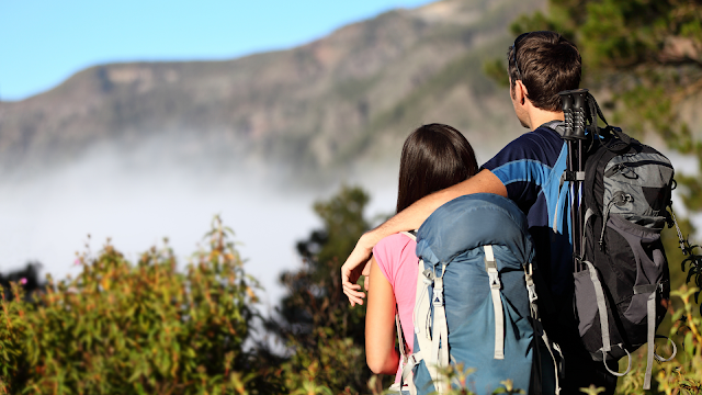 couple man women hiker mountain climber looking at mountain view and sea of clouds