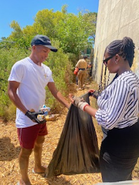 Mkuseli Khusi Veto and Lydia cleaning up trash at Greenpop eco hub.
