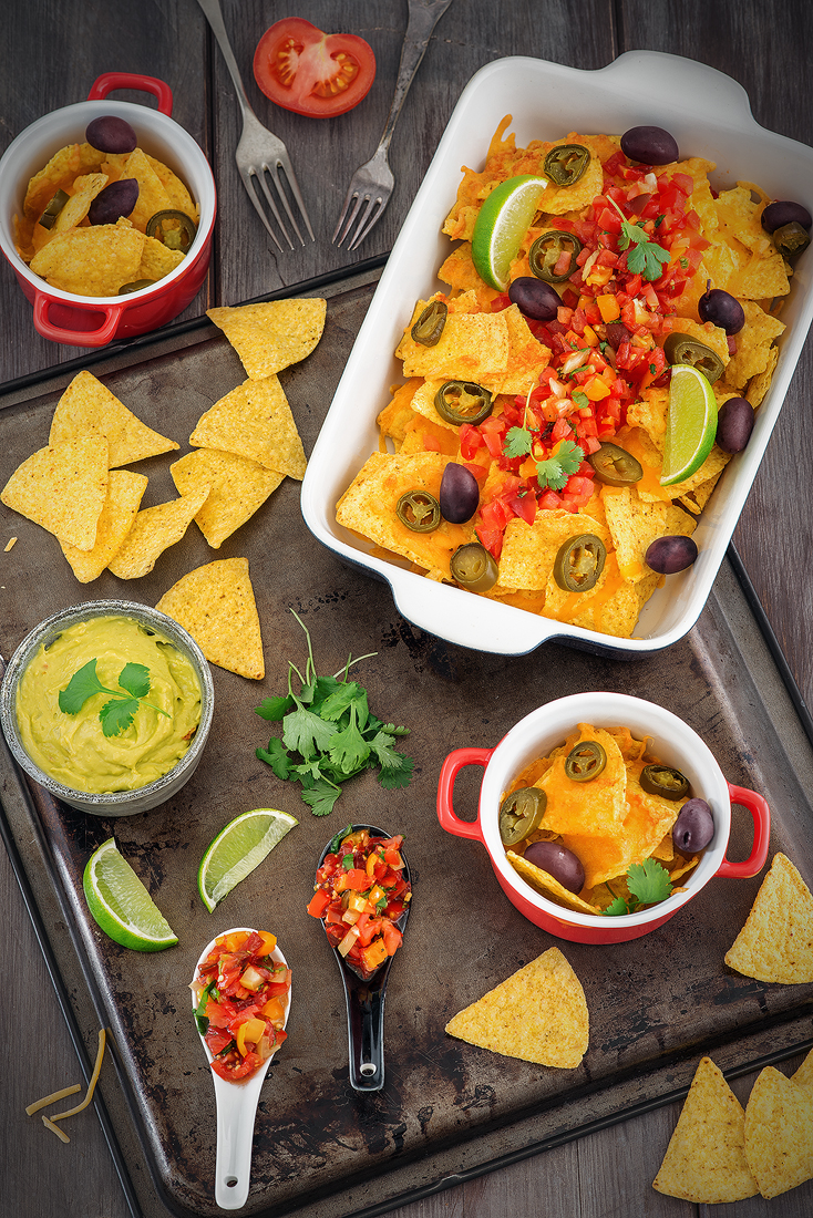 Tortilla chips with Cheddar cheese and tomatos