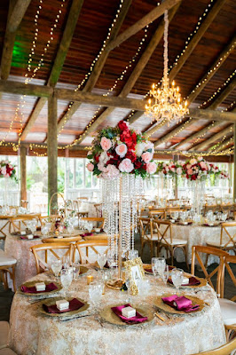 gold lace reception tables with tall floral centerpieces and gold chargers