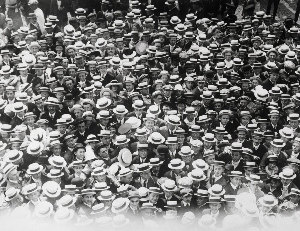 A sea of straw hats seen at a baseball match. 