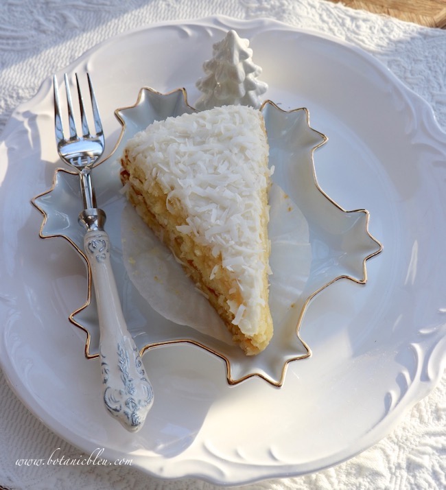 Moist coconut cake on a snowflake dessert plate is perfect for a snowy Winter tablesetting