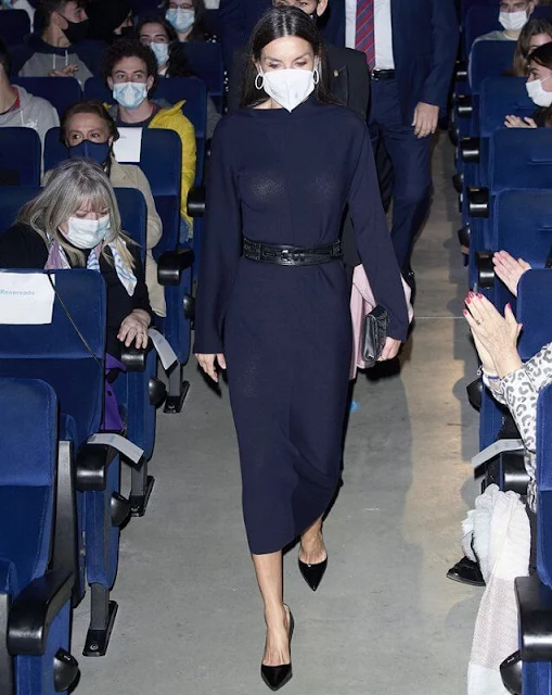 Queen Letizia wore a navy draped-neck ribbed wool dress from Cos. The Queen wore snakeskin embossed pumps from Manolo Blahnik