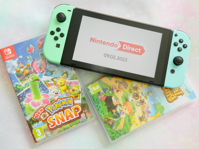 a photo showing a pastel green and blue Nintendo Switch console, along with two games: Animal Crossing New Horizons and Pokemon Snap