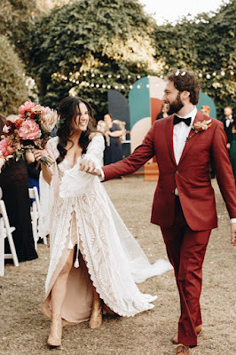 bride and groom walking down aisle holding hands