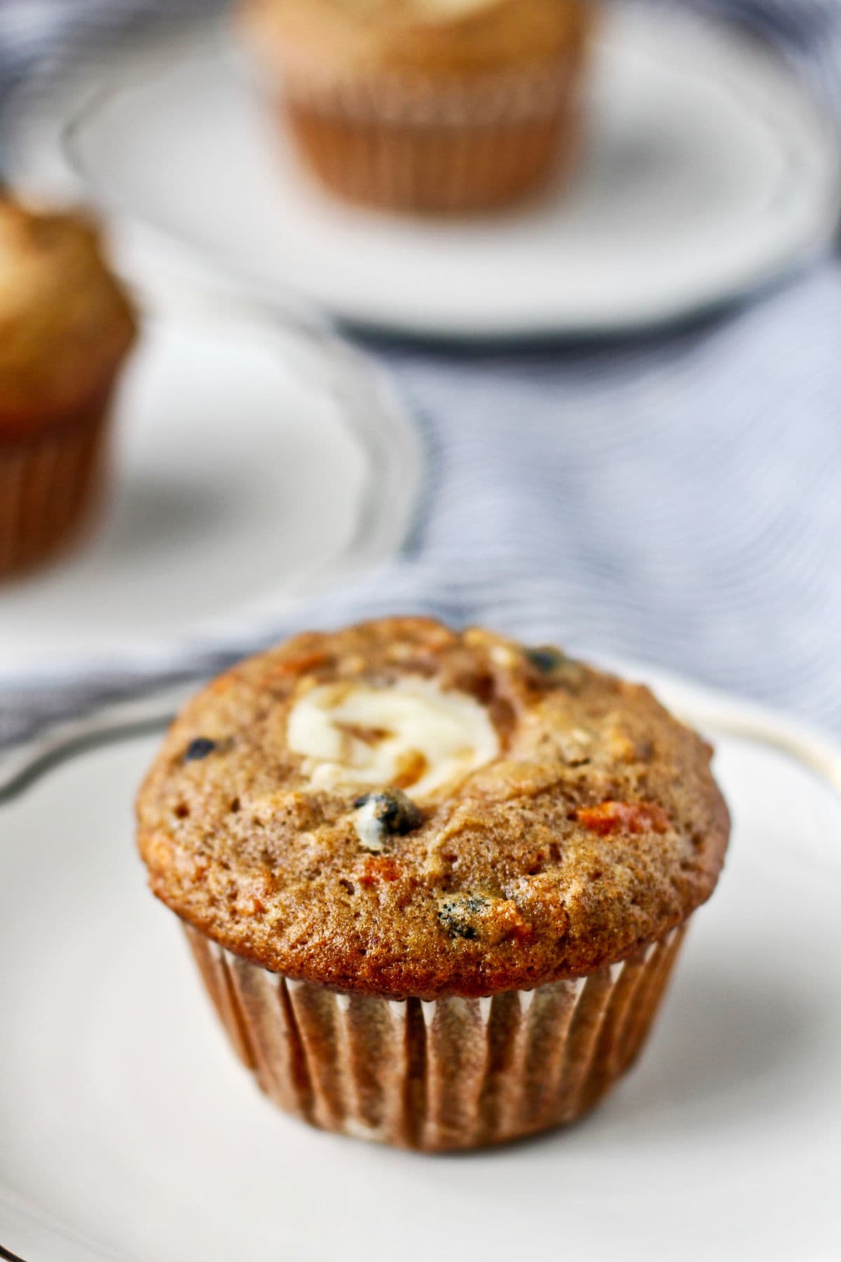 Morning Glory Muffins with Vanilla Cream Cheese Filling on plates.