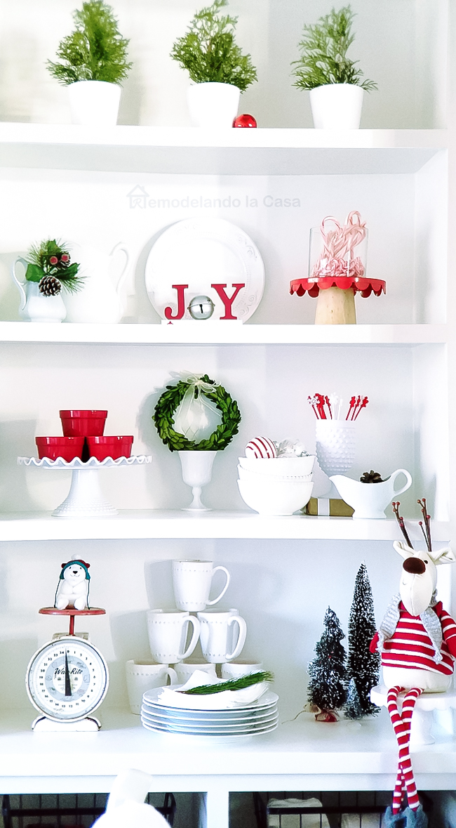 old scale and a toy moose are mix in the white and red decor