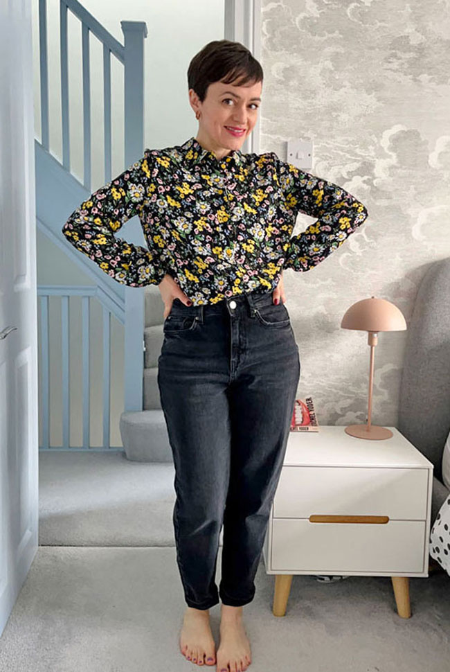 Tilly wears floral Lyra shirt with black jeans