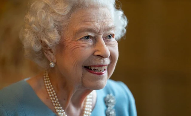 Queen Elizabeth wore a wedgewood and a blue crepe white brocade embroidered dress by Angela Kelly