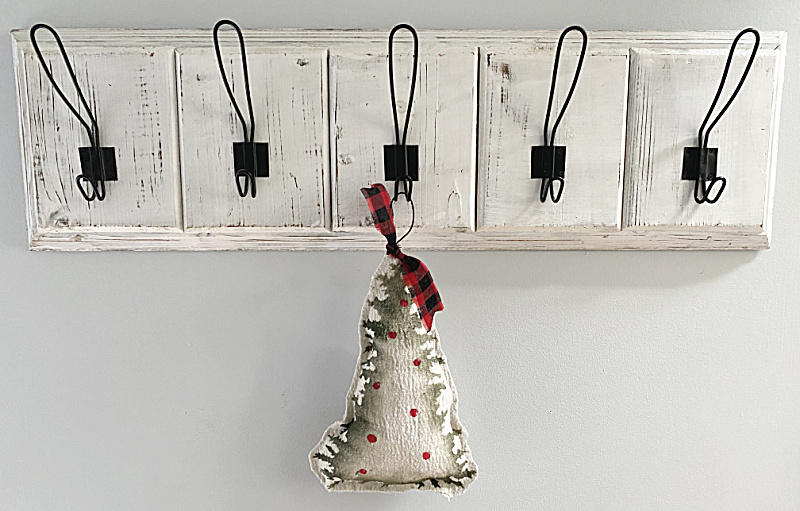 hook rack with hanging stuffed tree ornament