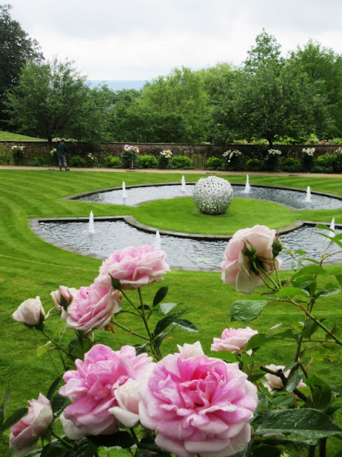 View of rose garden with ornamental pond and sculpture