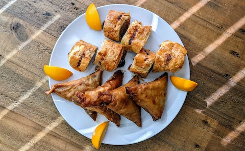 Snack platter: Turkey samosas and sausage rolls