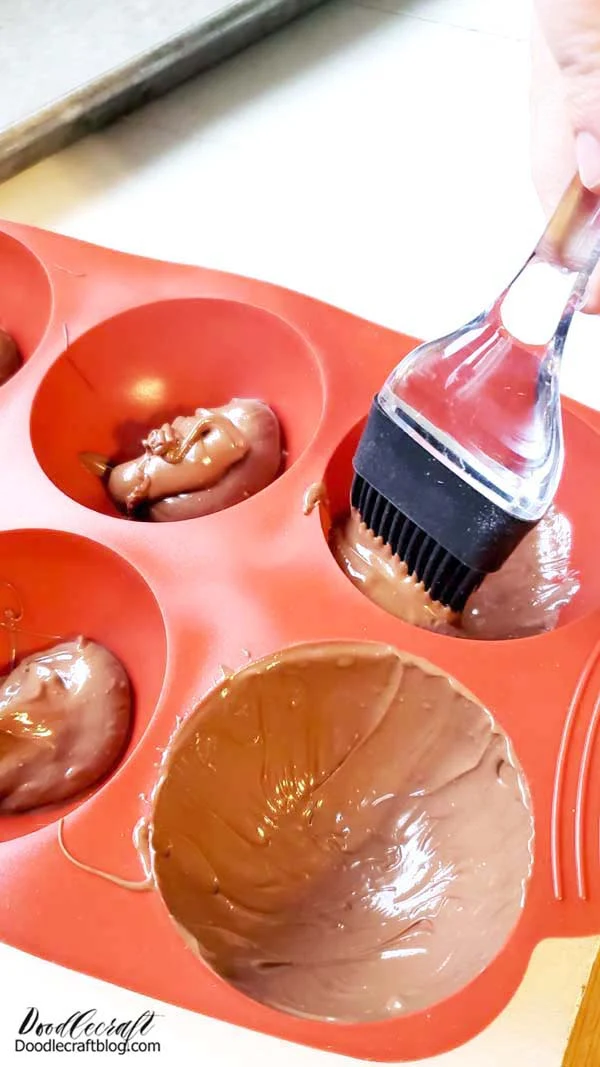 Step 1: Hot Chocolate Bomb Shells Begin by melting the chocolate candy melts according to the package directions. Then plop a spoonful in each cavity of the mold and use the basting brush to spread it around as evenly as possible.