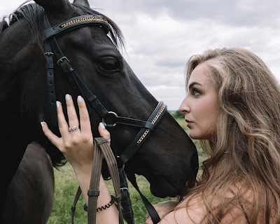 girl and a black horse
