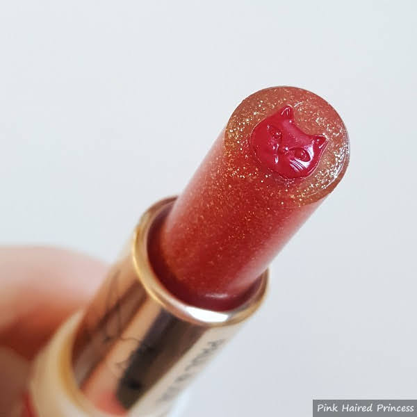 close up of cat lipstick with glitter transparent layer