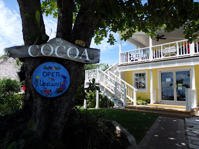 Front of coffee house with sign on tree
