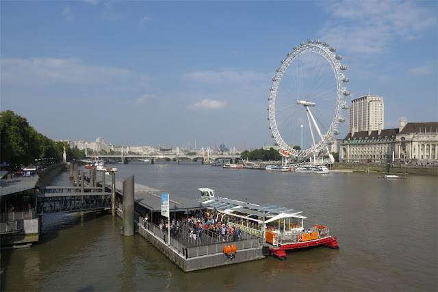 Millennium Wheel or London Eye with the Hungerford Bridge and Golden Jubilee Bridges, South Bank at County Hall, London