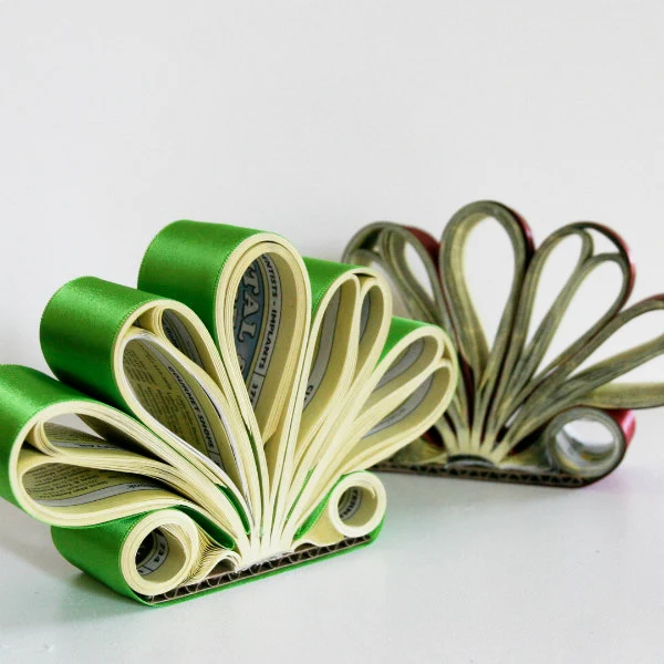 two phone book letter holders made of shaped rolls of book pages