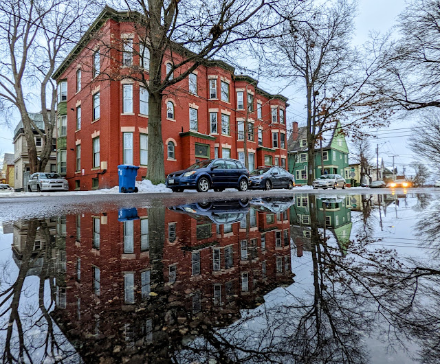Portland, Maine December 2021 photo by Corey Templeton. A classic three story building and its reflection on Emery Street.