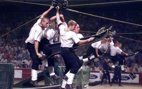 hunky sailors muscle guns over obstacles in teams