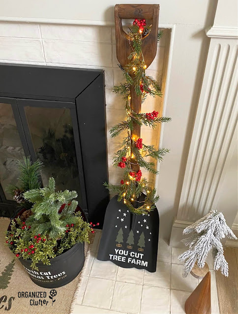 Photo of an upcycled shovel painted and stenciled with the Mini Christmas Trees Stencil from Old Sign Stencils.