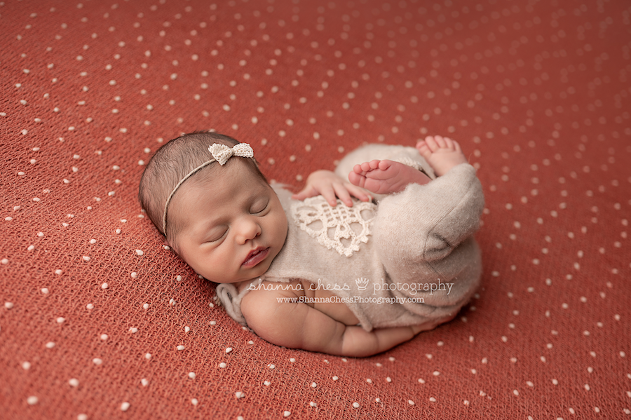 Sleeping baby girl on rust-colored beanie, best Eugene Oregon phototgraphers