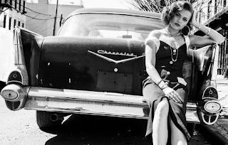 Andra Day posing for picture with a classical car
