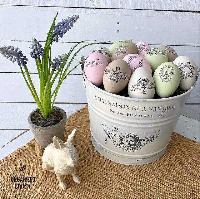 Photo of chalk painted faux Easter eggs decorated with rub on transfers.