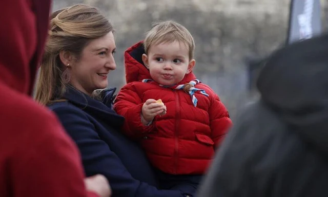 Princess Stephanie wore a blue Gibbsmoore coat by Burberry. Prince Charles wore a red puffer jacket by Petit Bateau