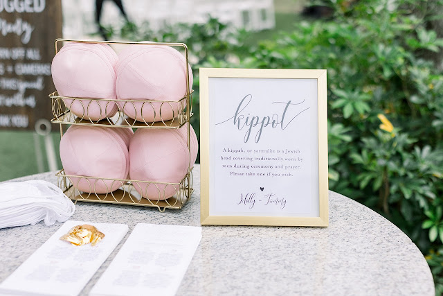 jewish welcome table with kippahs for wedding ceremony