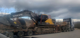 Big Volvo digger on a low loader