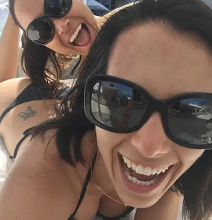 Autumn Calabrese clicking selfie showing her tattoos