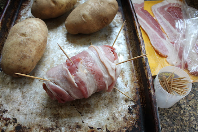 Wrap the potatoes with bacon. Overlap them and use three or four slices per potato.