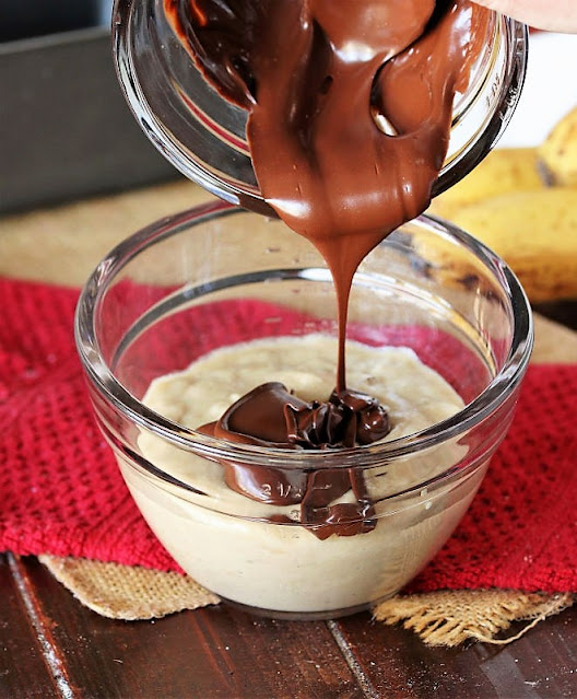 Pouring Melted Chocolate into Banana Bread Batter Image
