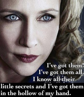 Close up of Vera Farmiga with the caption I've got them! I've got them all.  I know all their little secrets and I've got them in the hollow of my hand.