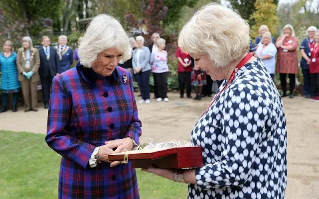 The Duchess wore a bold tartan coat and colour-block scarf, her favourite knee-high boots and Remembrance poppy pin