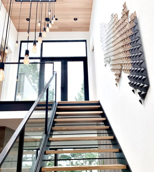 modern stairwell with display of modular origami wall art in neutral tones