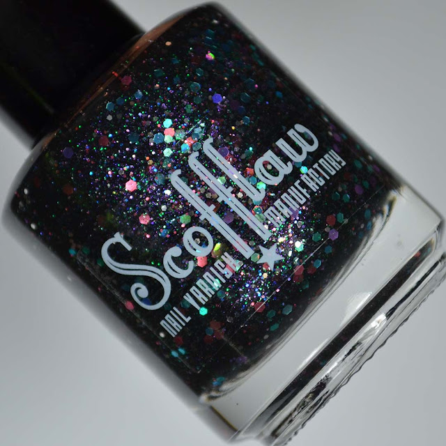 black nail polish with iridescent glitter in a bottle