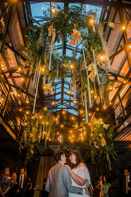 String Lights suspended in the main room and placed up-lights along the perimeter walls for a wedding reception at The Foundry.