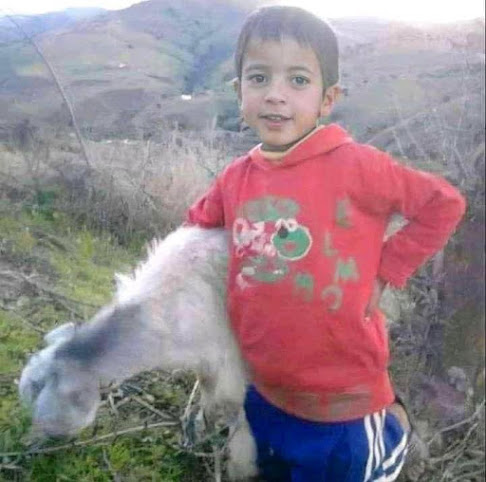 Rayan and a small goat in happier times