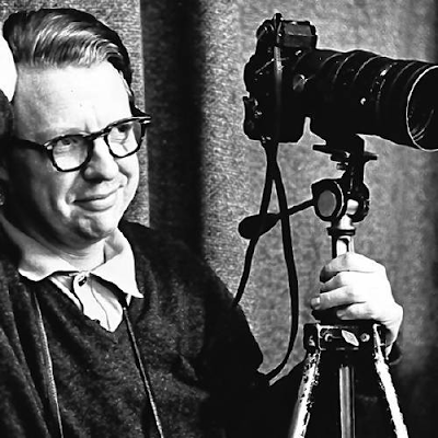 black and white photograph of Don Hunstein with his camera