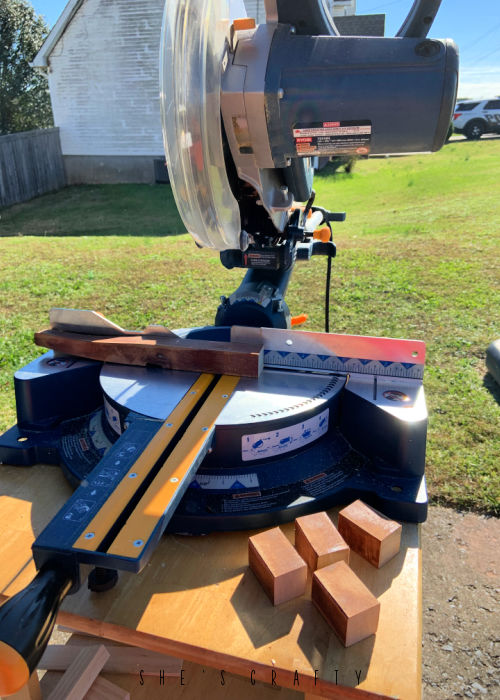 Use miter saw to cut down table legs to make place card holder.