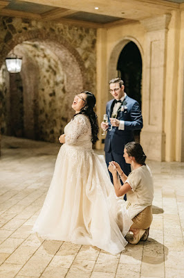 at last weddings coordinator fixing dress