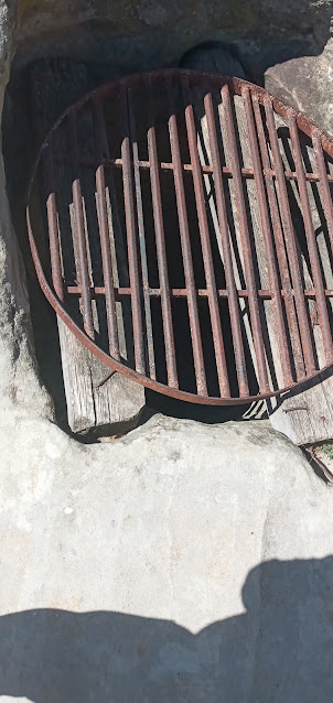 Ancient abandoned well inside Uplistsikhe cave town ruins.