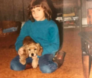 Childhood picture of Krystal Ball with a dog