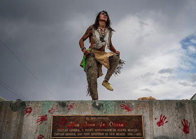 Male Native American dances on top of pedestal where a statue of Spanish Conquistidor Juan de Onate was removed, New Mexico, 2020