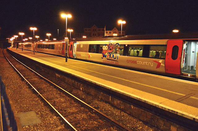 Colourful night photo of Cross Country Super Voyager DMU train Class 221138 emblazoned with event logo 'The Big Hoot' on its side at Banbury train station 2016