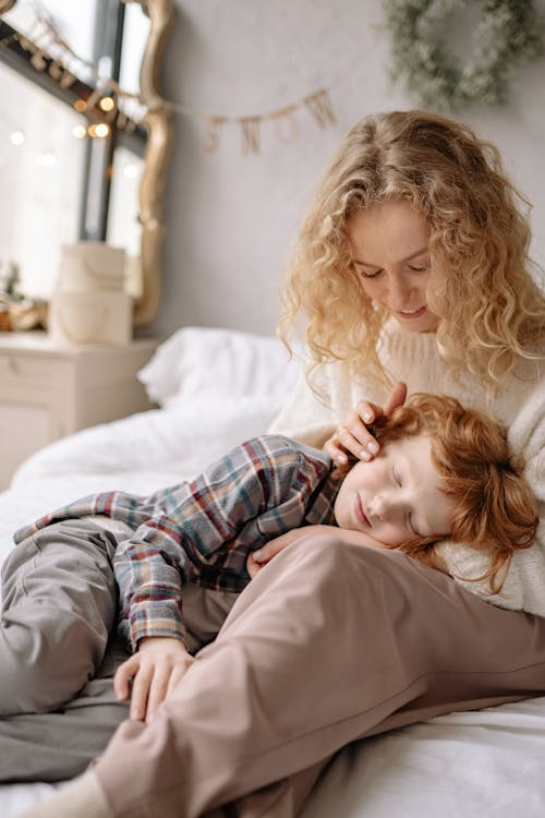 Warm and tender moment of a mother and son bonding indoors, capturing affection and comfort.
